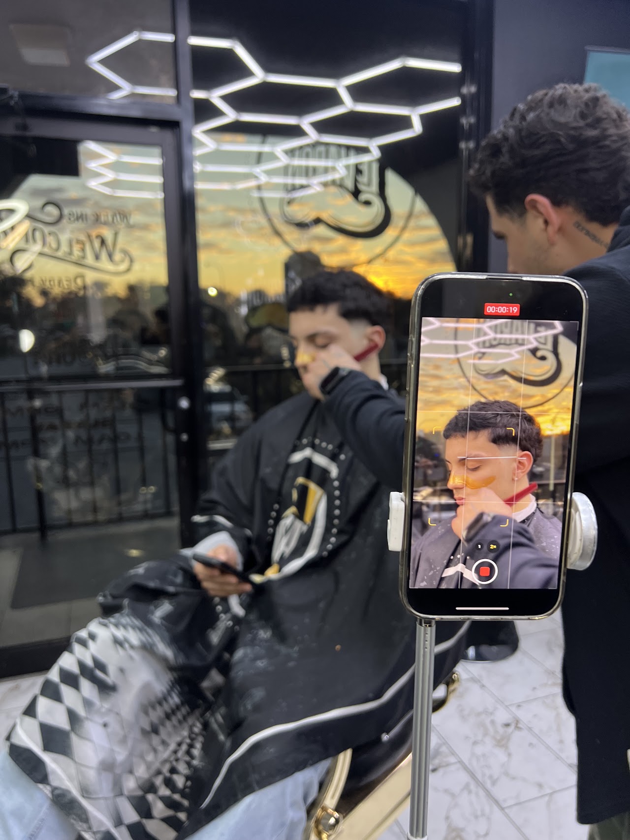 Barber at Le Varon Barbershop giving a client a haircut