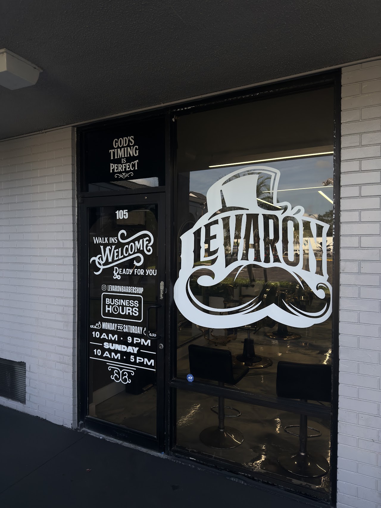 Le Varon Barbershop front door and business hours sign